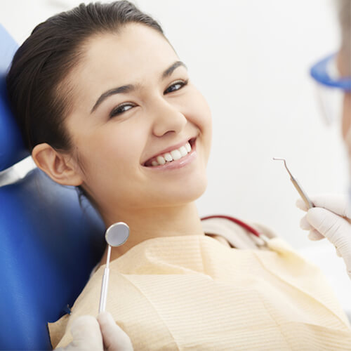 Young woman smiling in a dental chair