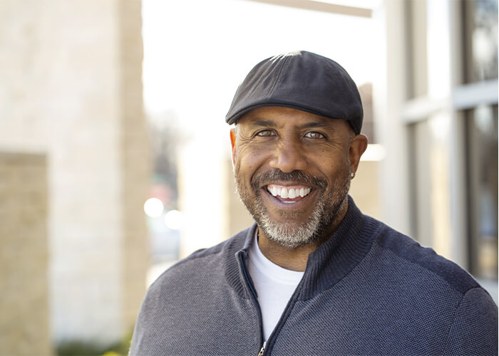 Portrait of a man in a cap with a big smile